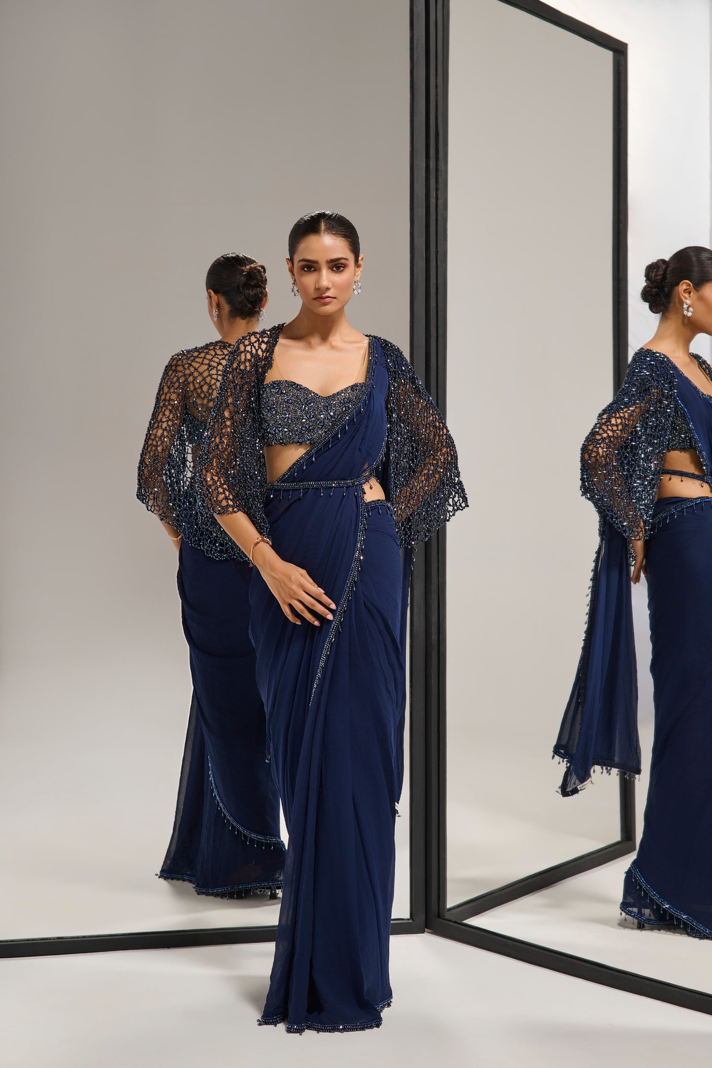 Navy blue saree set with
crystal cape