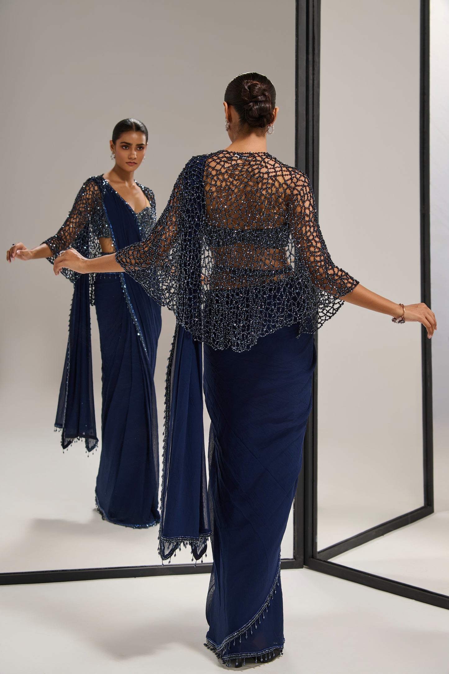 Navy blue saree set with
crystal cape