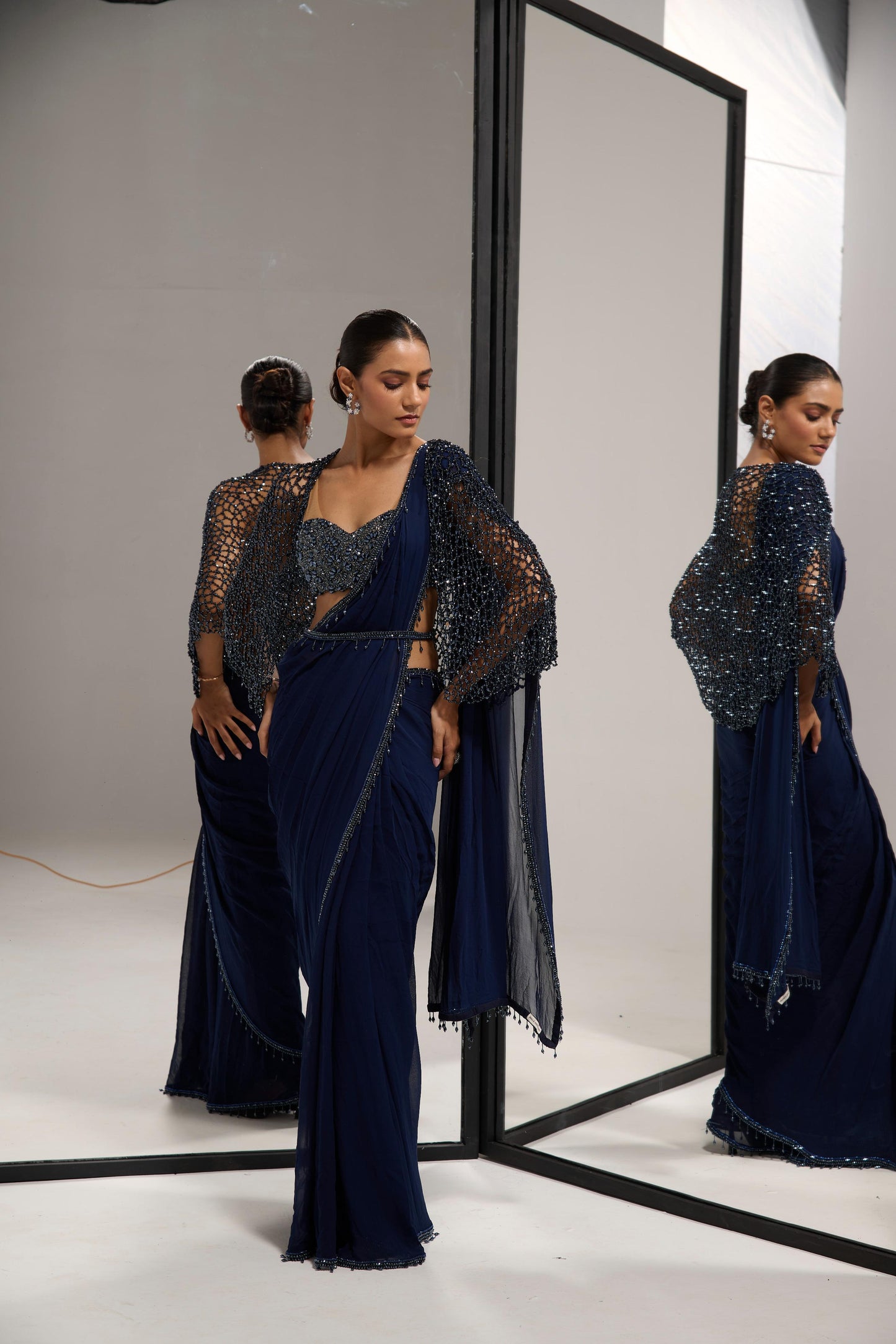 Navy blue saree set with
crystal cape